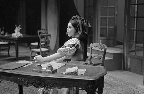 woman singing opera at desk