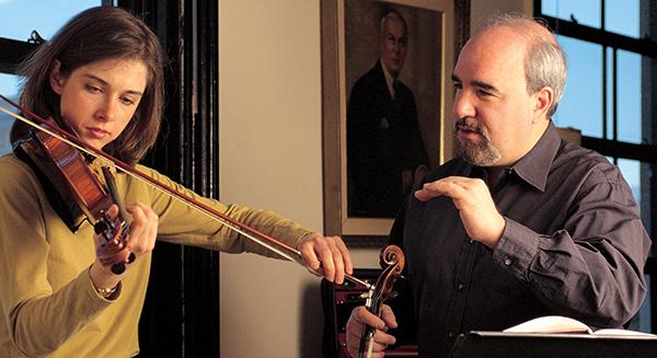 man with violin teaching student